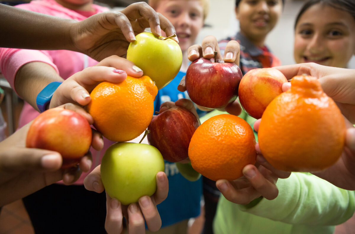 Image of children holding different fruits